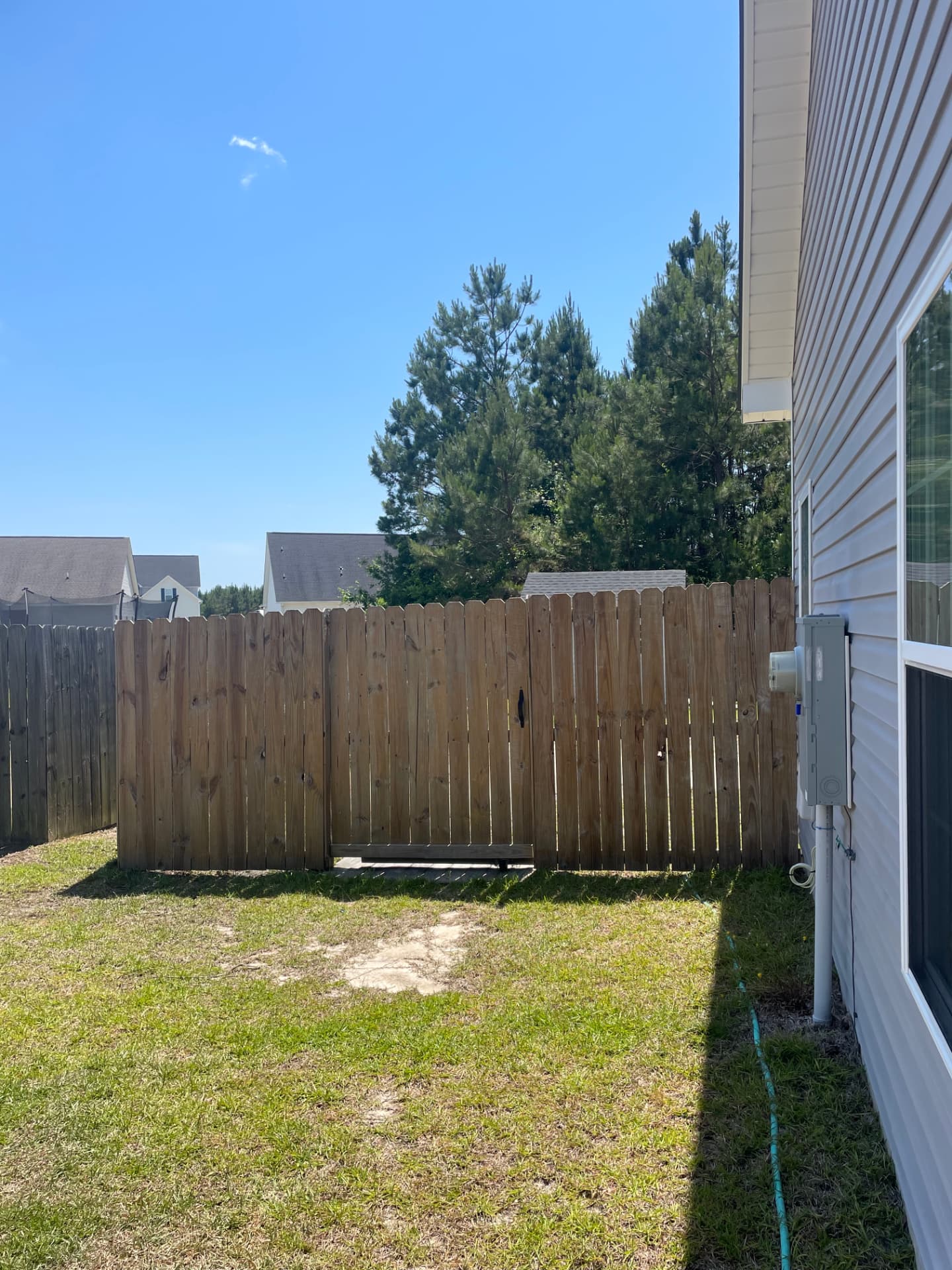 Fence cleaning after, Jacksonville, NC: wood privacy fence soft washed back to bare clean grain