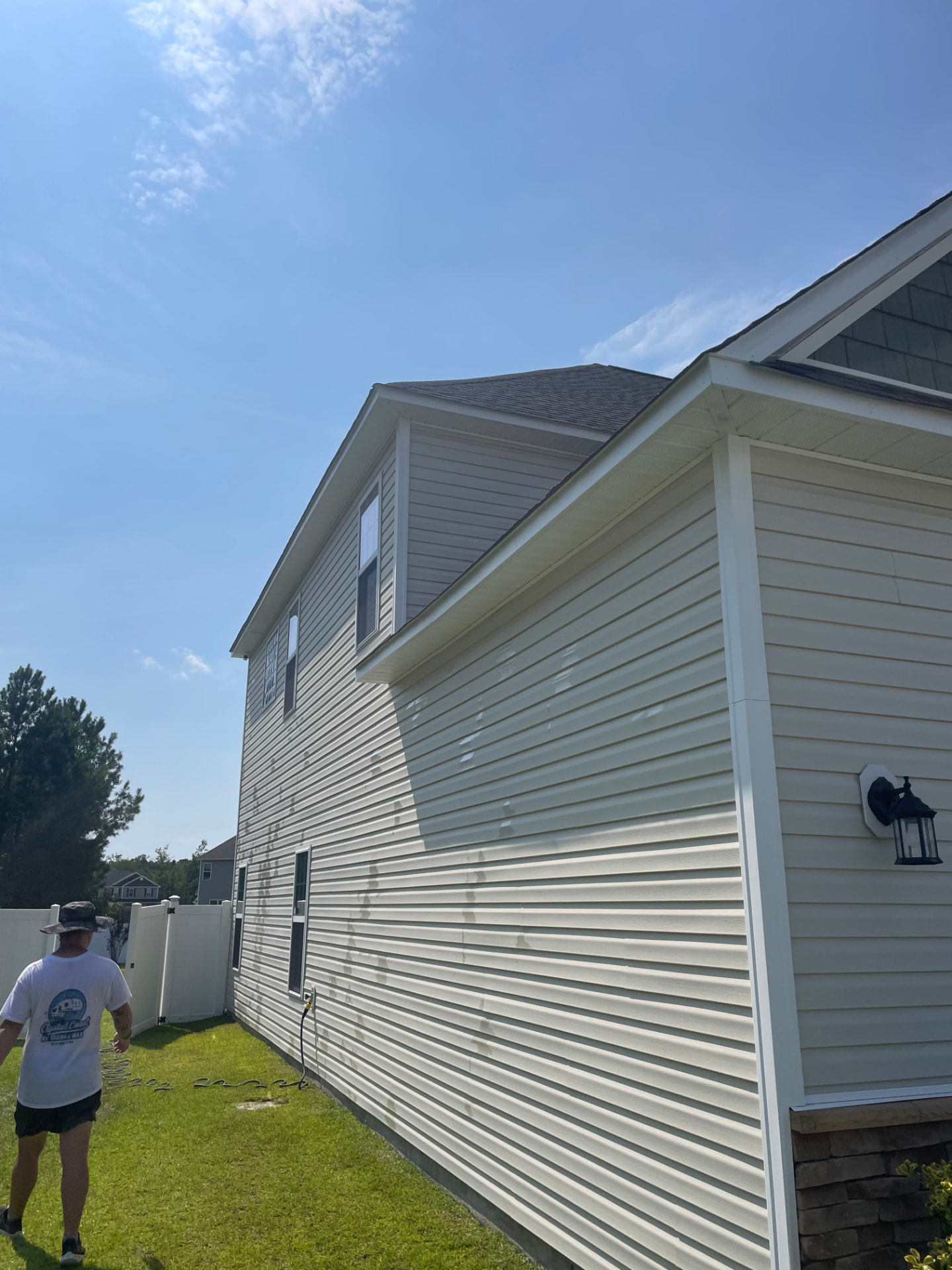 House washing after, Jacksonville, NC: beige siding wall soft washed clean of green algae